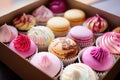 an open bakery box with a selection of cupcakes Royalty Free Stock Photo