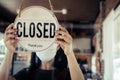 Open. barista, waitress woman wearing protection face mask turning open sign board on glass door in modern cafe coffee shop, cafe Royalty Free Stock Photo