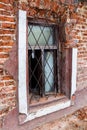 An open barred window on a crumbling brick wall Royalty Free Stock Photo