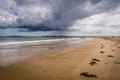 An open beach with a big dramatic sky