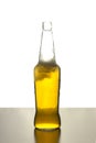 Open beer bottle with foam on an isolated background on the table Royalty Free Stock Photo