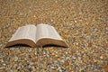 Open bible on beach pebbles Royalty Free Stock Photo