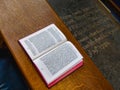 Open bible on bench in church