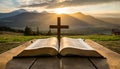 Open bible book on a wooden table at sunset with cross in front of it. Strong Christian faith Royalty Free Stock Photo