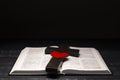 Open Bible. Cross of Jesus. Crucifixion on a book. Prayer. Love for God. Red heart.