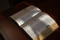 Open bible on a dark wood table Royalty Free Stock Photo