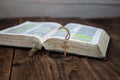 A open bible and golden cross on wooden background Royalty Free Stock Photo