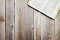 An open Bible over the wooden table with copy space. Christian concept. Royalty Free Stock Photo