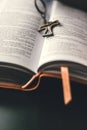 An open bible is placed on a black surface table.