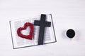 An open Bible on the table. The cross and heart are a symbol of God\'s love for people. Prayer Royalty Free Stock Photo