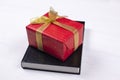 An open Bible on the table. A gift on a book. A red gift-wrapped box with a gold bow. A gift from God Royalty Free Stock Photo