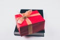 An open Bible on the table. A gift on a book. A red gift-wrapped box with a gold bow. A gift from God Royalty Free Stock Photo