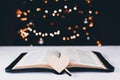An open Bible on the table. The heart is a symbol of God\'s love for people. Prayer. On the background of the Christmas tree Royalty Free Stock Photo