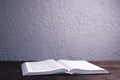 An open Bible on the table. Holy Scripture on a wooden background. Prayer to pray Royalty Free Stock Photo