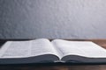 An open Bible on the table. Holy Scripture on a wooden background. Prayer to pray Royalty Free Stock Photo