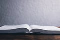 An open Bible on the table. Holy Scripture on a wooden background. Prayer to pray Royalty Free Stock Photo