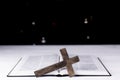 An open Bible on the table. Prayer. Wooden cross. Crucifix. Holy Scripture. On the background of the Christmas tree. Royalty Free Stock Photo