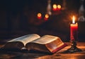 open bible on wood table with red candle Royalty Free Stock Photo