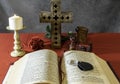 Open bible and wooden cross with burning candle Royalty Free Stock Photo