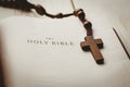 Open bible and wooden rosary beads Royalty Free Stock Photo