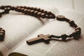 Open bible and wooden rosary beads Royalty Free Stock Photo