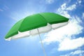 Open big green beach umbrella and beautiful blue sky with white clouds on background Royalty Free Stock Photo