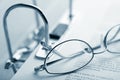 Open binder and glasses over document Royalty Free Stock Photo