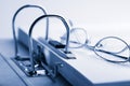 Open binder and glasses over document Royalty Free Stock Photo