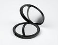 Open Black Compact Makeup Mirror with Dual Reflective Surfaces on White Background Royalty Free Stock Photo