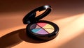 Open black compact of multi-colored cosmetic powder or eyeshadow palette, featuring vibrant, rainbow-like shades with dramatic Royalty Free Stock Photo