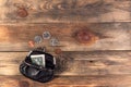 Open black leather pocket wallet with coins one cent, quarter dollar and 2 dollars banknote nearby. Financial crisis, poverty, Royalty Free Stock Photo