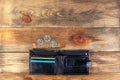 Open black leather pocket wallet with coins one cent and a quarter dollar nearby. Financial crisis, poverty, lack of money. On Royalty Free Stock Photo