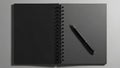 Open Black Spiral Notebook with Pen on Grey Background Royalty Free Stock Photo