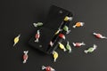Open black wallet with many colorful candies, flat lay on dark background, concept of spend money or devaluation Royalty Free Stock Photo