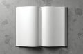 Open blank book pages lie on textured gray surface. Ready for text or art, this clean template offers empty space for designs or Royalty Free Stock Photo