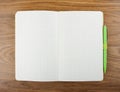 Open blank checked notebook with green pen on a table. Royalty Free Stock Photo