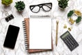 Open blank note book, glasses, cup of coffee, pen, smartphone, succulents on marble table Royalty Free Stock Photo