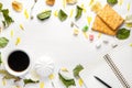 An open blank notebook and a black pencil, cup of coffee and cookies on a white wooden background among dry leaves and flower Royalty Free Stock Photo