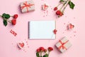 Open blank notebook with gift box, flowers and hearts on a pink background. Valentines day background. Royalty Free Stock Photo