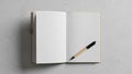 An open blank notebook with a light brown cover lies on a textured gray Royalty Free Stock Photo