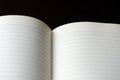 Open blank notebook with lined pages on a dark background close-up. Educational or business concept Royalty Free Stock Photo
