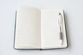 Open blank notebook with lined pages and pen placed on top, isolated on white background Royalty Free Stock Photo