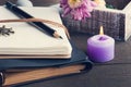 Open blank notebook, lit candle, flower Royalty Free Stock Photo