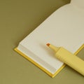 Open blank notebook and yellow highlighter on desk Royalty Free Stock Photo