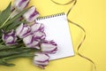 Open blank notepad and bouquet of flowers on table top view in flat lay style. Female desk top Royalty Free Stock Photo
