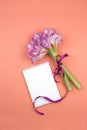 Open blank notepad and bouquet of pink flowers on table top view in flat lay style Royalty Free Stock Photo