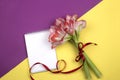 Open blank notepad and bouquet of pink flowers on table top view in flat lay style Royalty Free Stock Photo