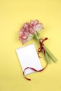 Open blank notepad and bouquet of pink flowers on table top view in flat lay style Royalty Free Stock Photo