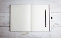 Open blank notepad with empty pages with a pencil
