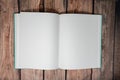 Open blank paper book and bullet journal with no writing on the pages, over a dark wooden background Royalty Free Stock Photo